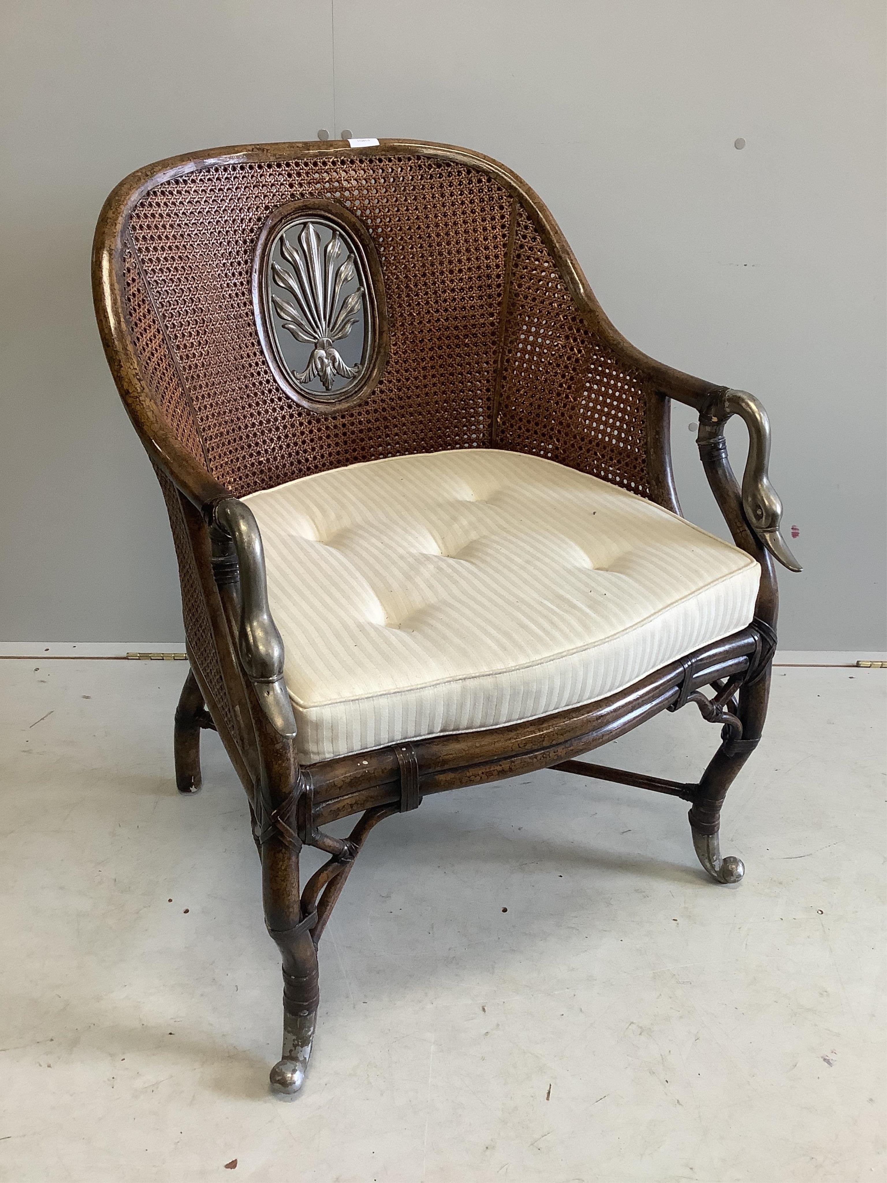 An Empire style caned back bergere, with swan’s head arms, width 66cm, depth 62cm, height 90cm. Condition - good